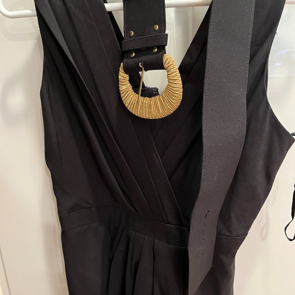 Sleeveless little black dress with gold buckled belt